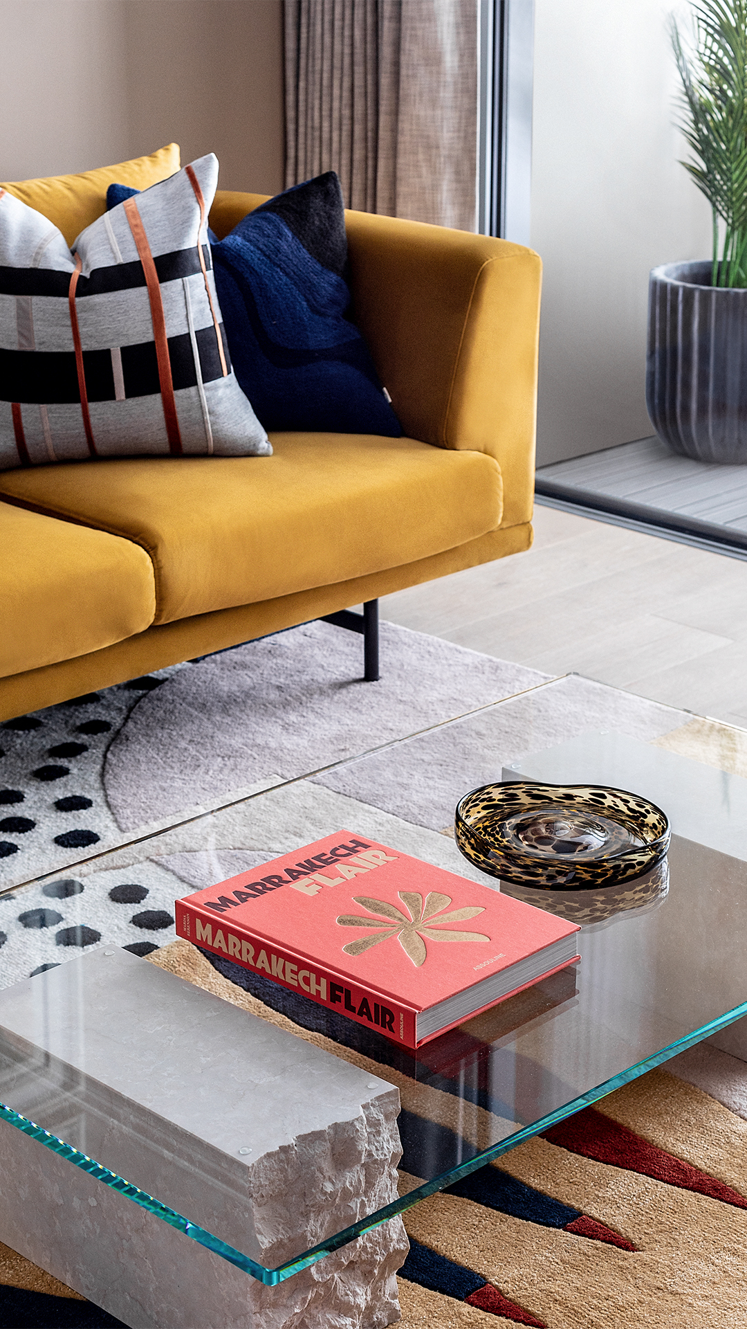 Colourful Interior with industrial style glass coffee table