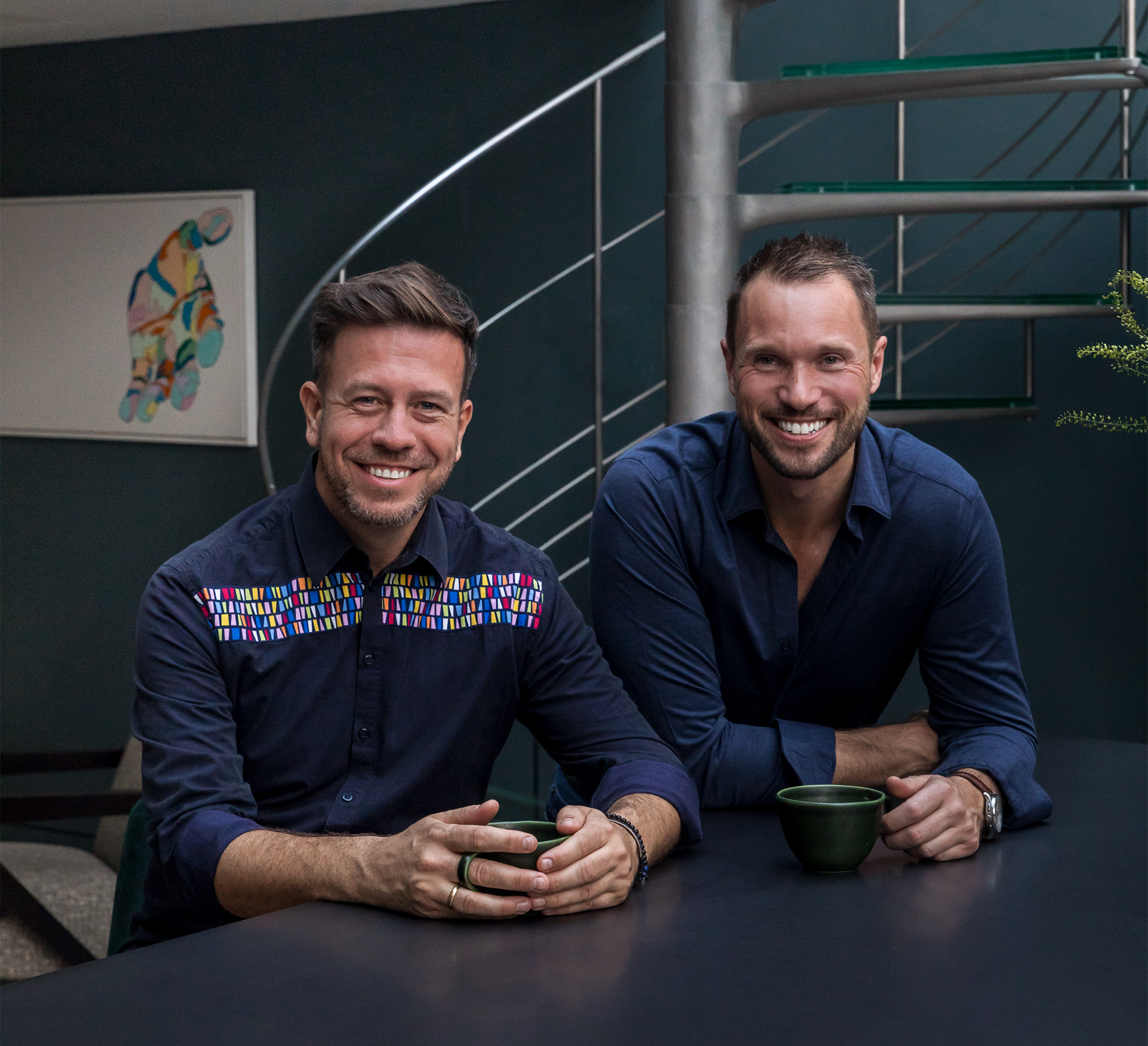 Richard Angel and Ed O'Donnell smiling in Soho Apartment