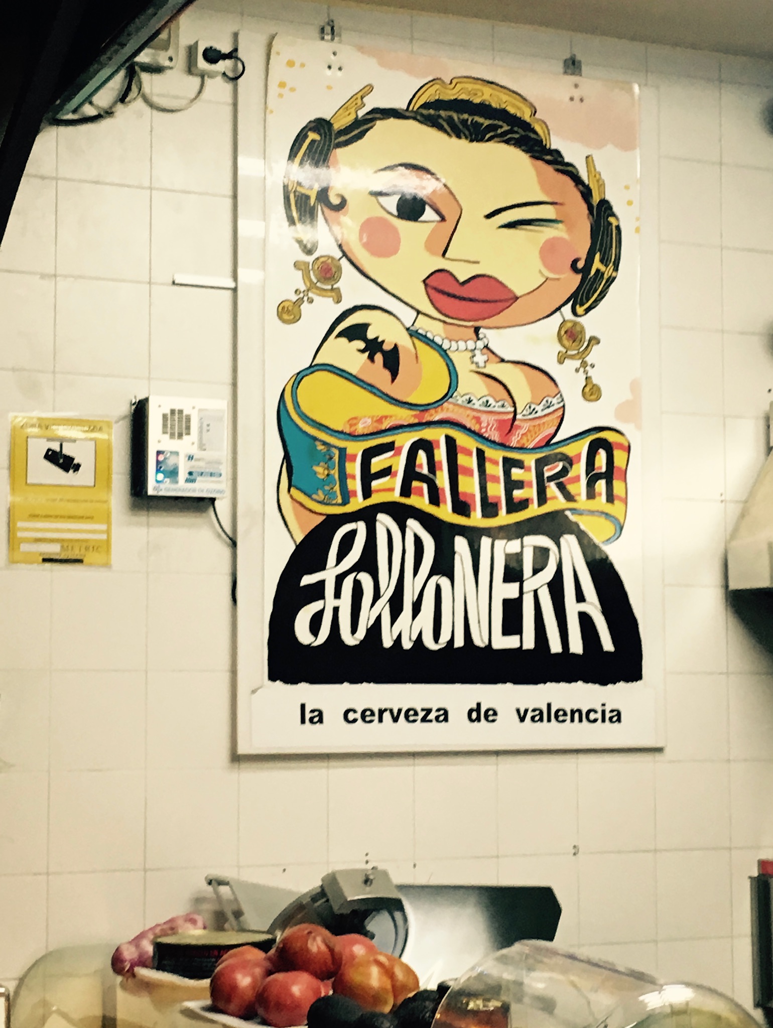 Food store poster of Spanish woman winking Follonera Fallera